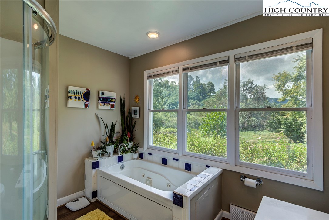 1046 J E Gentry Road Laurel Springs, NC 28644 - Photo 21 of 49 a bathroom with a tub and sink