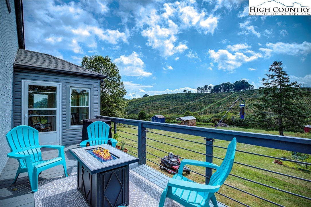 1046 J E Gentry Road Laurel Springs, NC 28644 - Photo 10 of 49 a view of a chairs and table in the balcony
