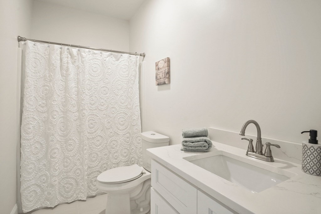 5 Squire Drive Wilbraham, MA 01095 - Photo 17 of 42 a bathroom with a sink a toilet and a mirror