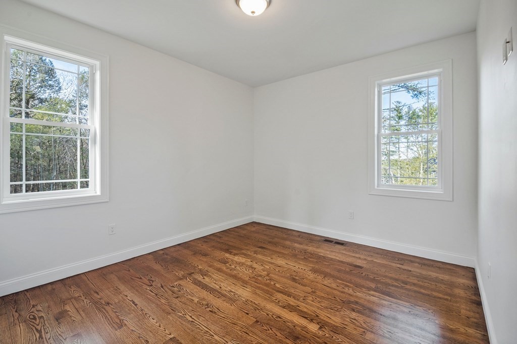 5 Squire Drive Wilbraham, MA 01095 - Photo 18 of 42 a view of an empty room with wooden floor and a window
