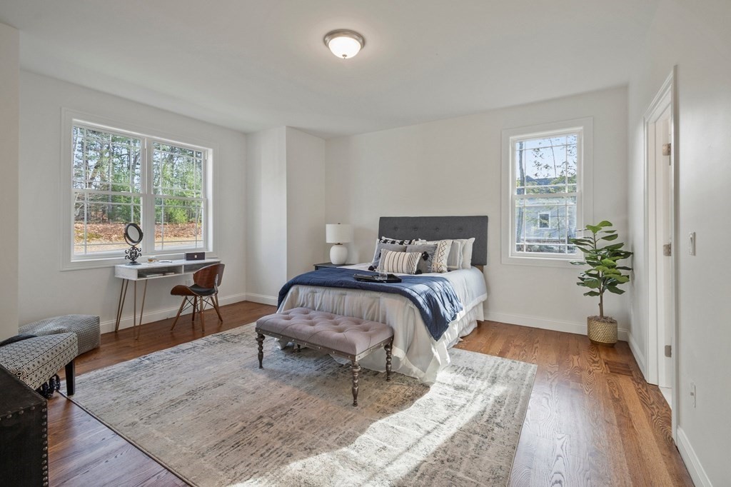 5 Squire Drive Wilbraham, MA 01095 - Photo 22 of 42 a bedroom with a bed and a table in it with wooden floor
