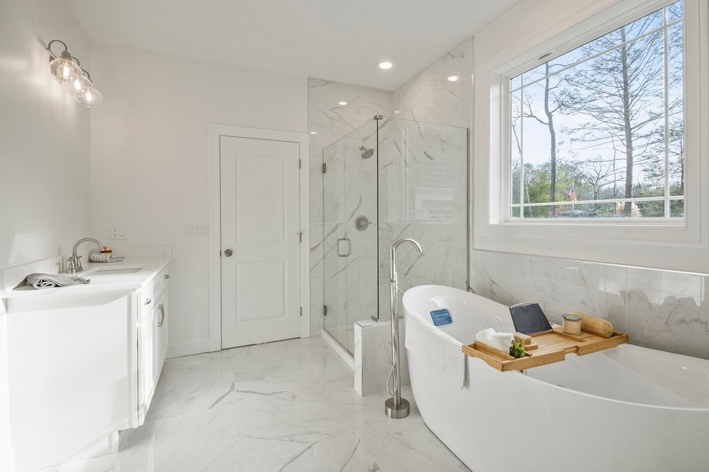 5 Squire Drive Wilbraham, MA 01095 - Photo 26 of 42 a bathroom with a tub a sink a mirror and a shower