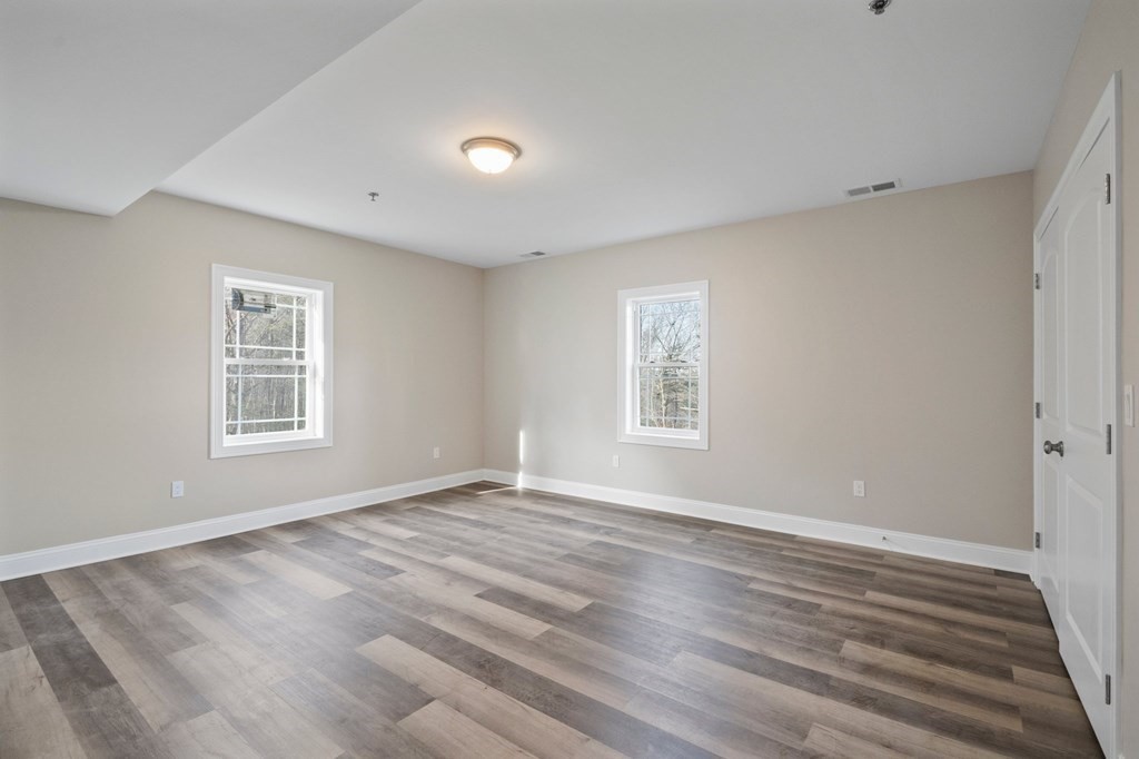 5 Squire Drive Wilbraham, MA 01095 - Photo 29 of 42 a view of an empty room with wooden floor and a window