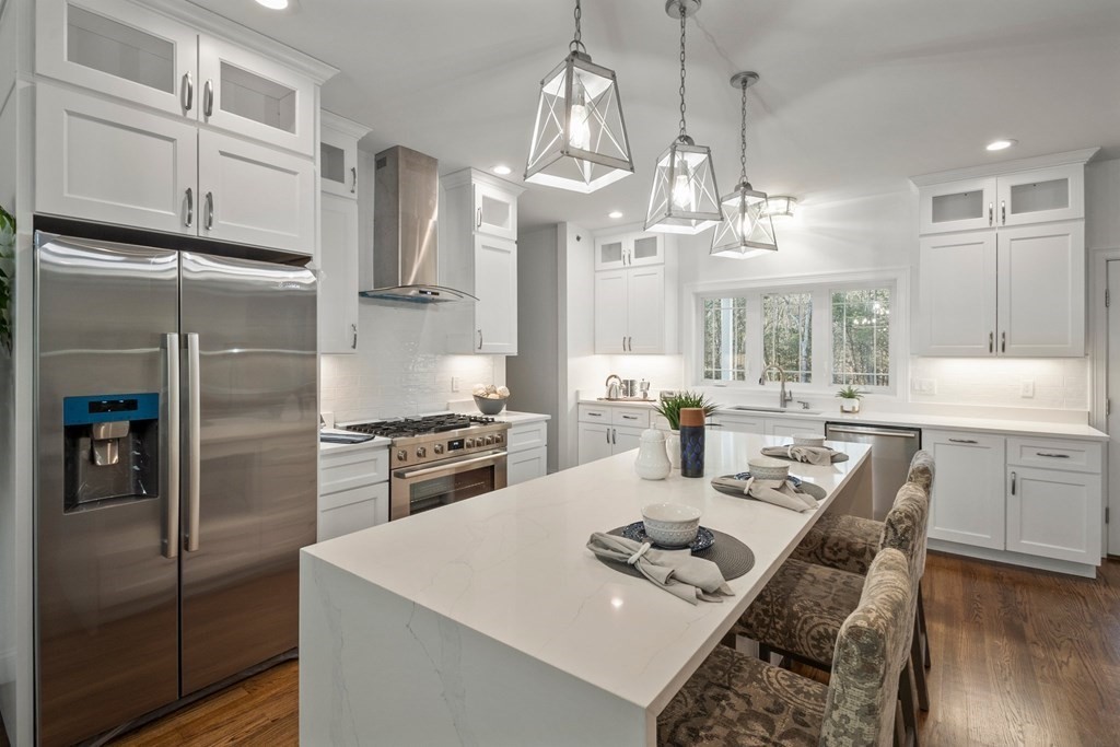 5 Squire Drive Wilbraham, MA 01095 - Photo 5 of 42 a kitchen with a refrigerator a sink dishwasher a stove and a dining table with wooden floor