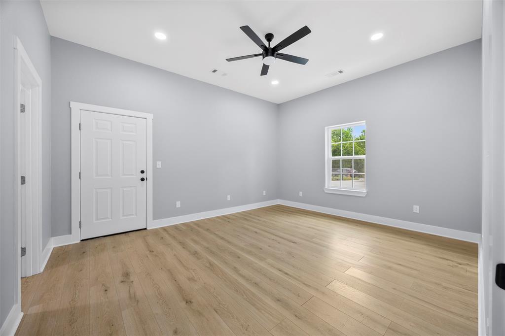 121 Brazier Road Ennis, TX 75119 - Photo 13 of 31 wooden floor in an empty room with a window