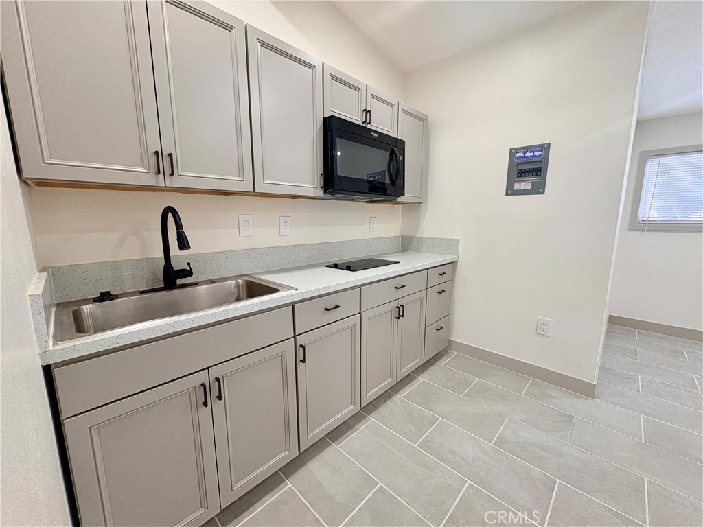 4585 Hawthorne Street, Unit B Montclair, CA 91763 - Photo 2 of 6 a kitchen with stainless steel appliances granite countertop a sink and a microwave