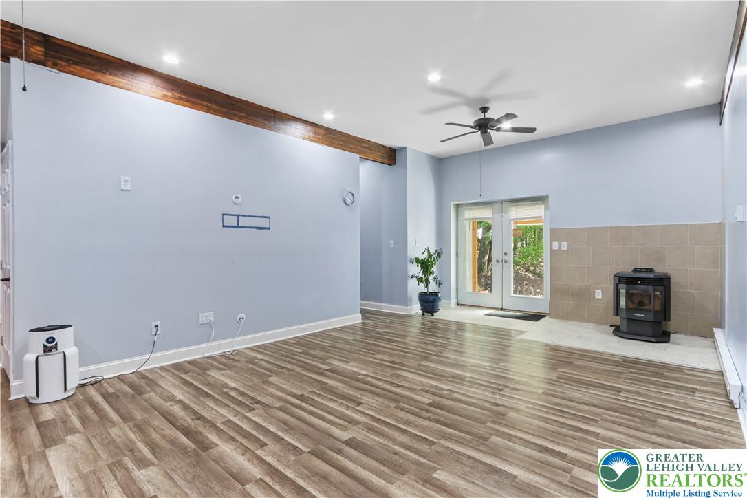 1007 Hampstead Road Bushkill, PA 18324 - Photo 37 of 72 A spacious room features rich wood beam accents and durable wood flooring.