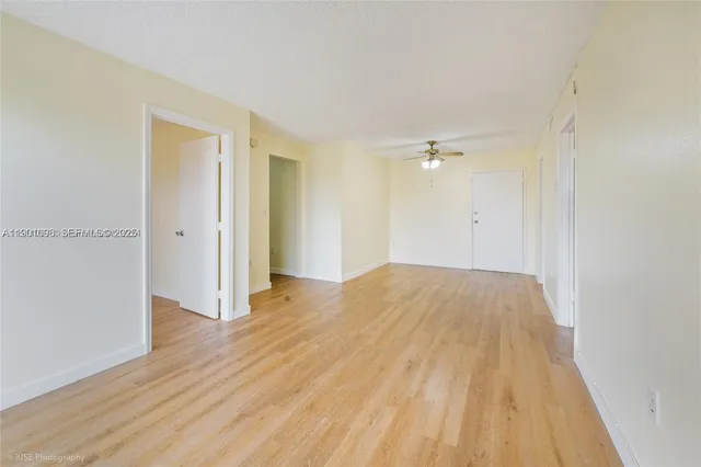 a view of a room with wooden floor