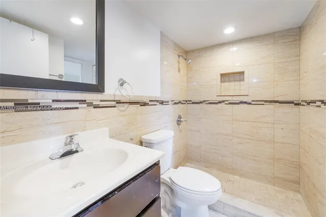 a bathroom with a sink a toilet and mirror