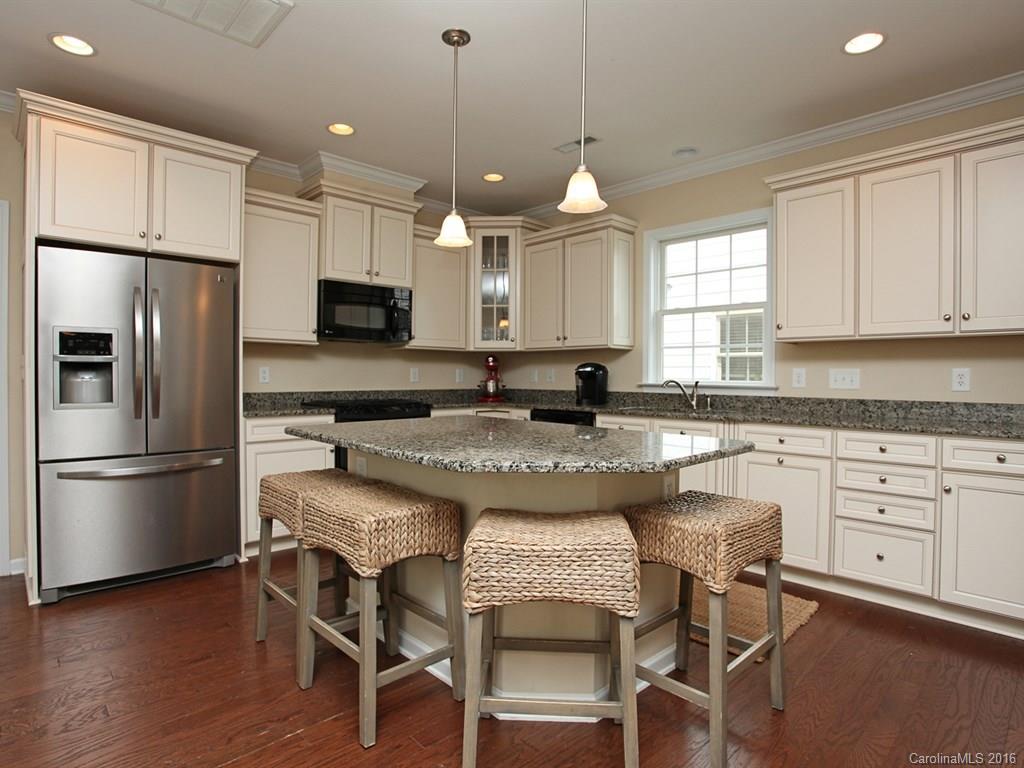 3442 Richard's Crossing Fort Mill, SC 29708 - Photo 14 of 24 a kitchen with granite countertop a sink stainless steel appliances and white cabinets