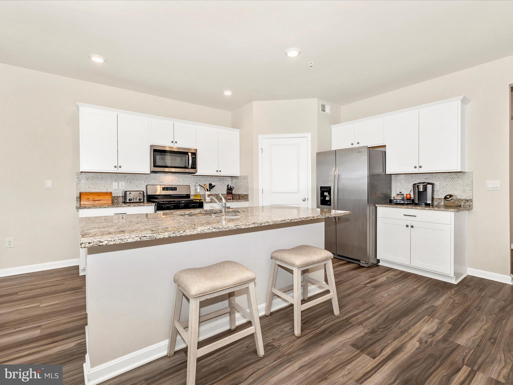 2088 Pomona Way Frederick, MD 21702 - Photo 11 of 55 a kitchen with granite countertop white cabinets and stainless steel appliances