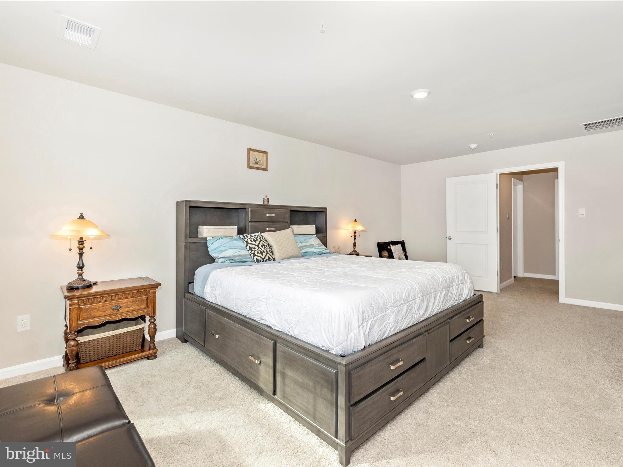 2088 Pomona Way Frederick, MD 21702 - Photo 24 of 55 a spacious bedroom with a bed and a lamp