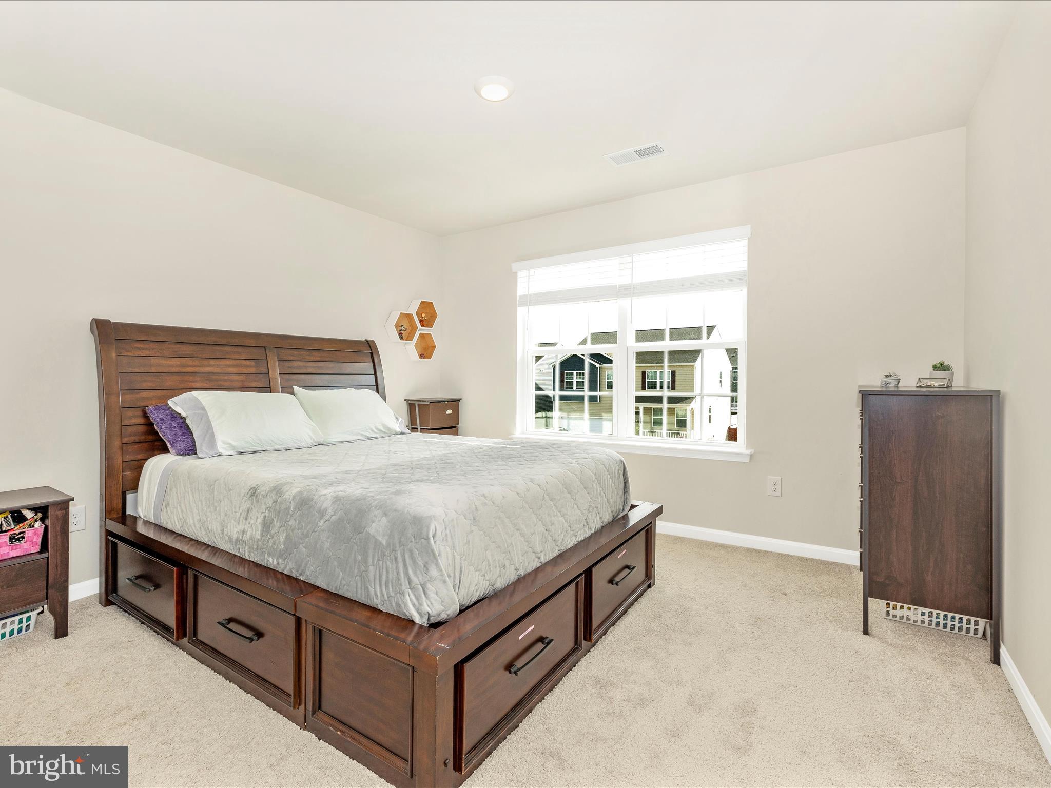 2088 Pomona Way Frederick, MD 21702 - Photo 31 of 55 a bed sitting in a bedroom next to a window