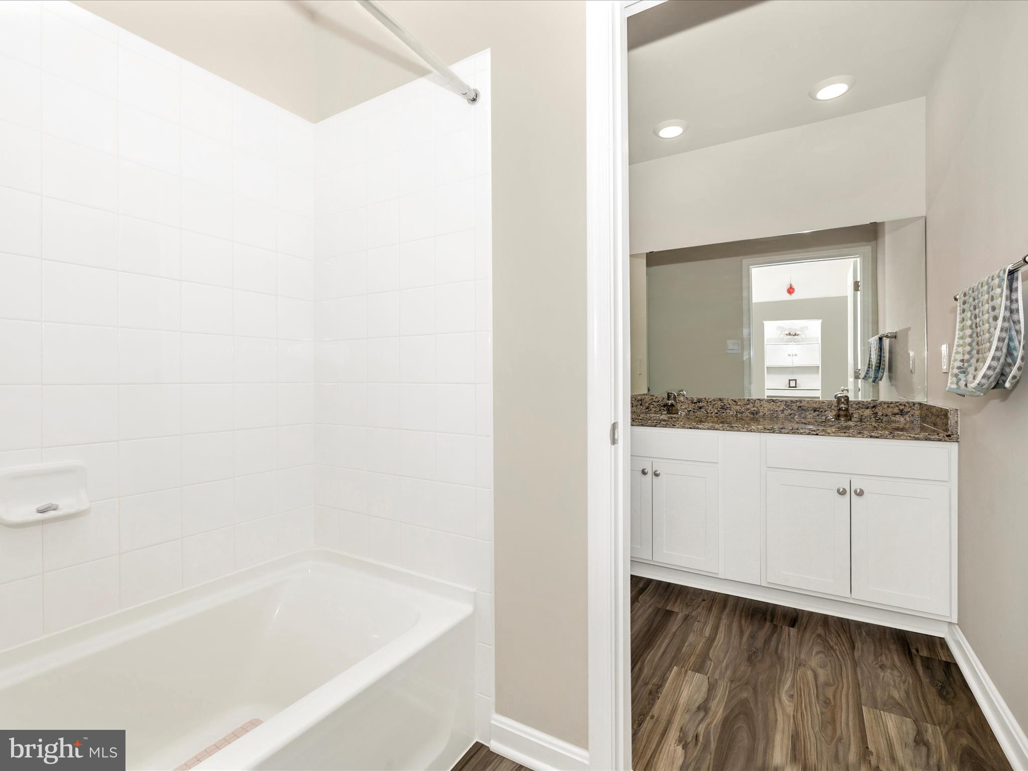 2088 Pomona Way Frederick, MD 21702 - Photo 34 of 55 a bathroom with a bathtub sink and mirror