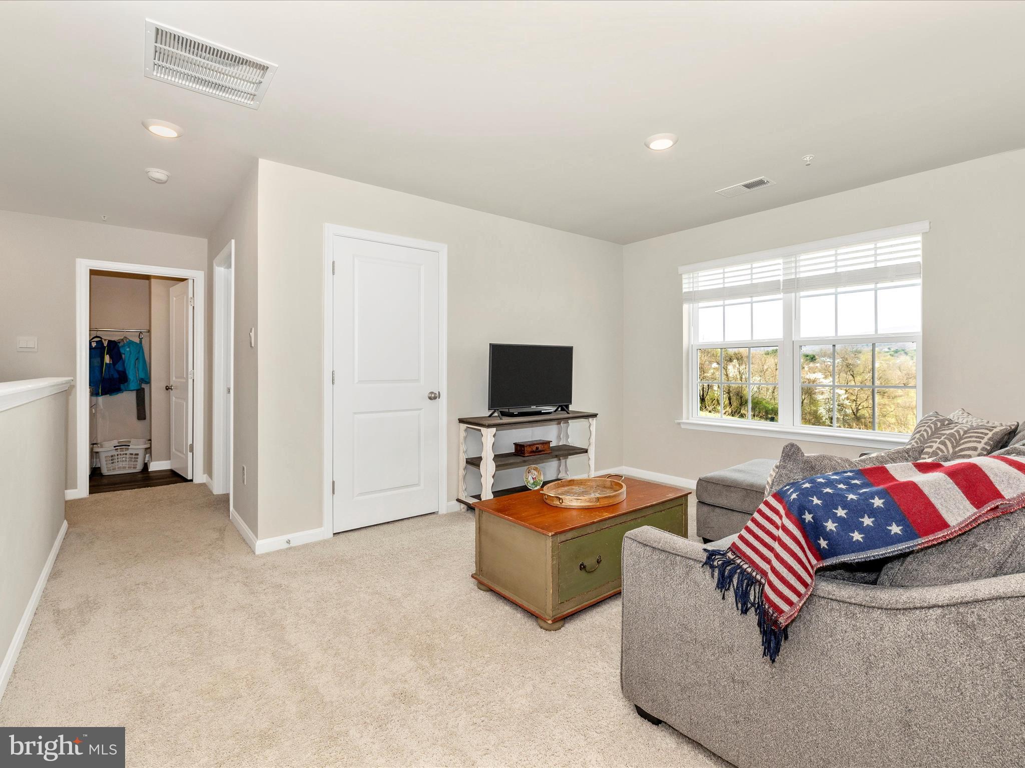2088 Pomona Way Frederick, MD 21702 - Photo 35 of 55 a living room with furniture and a flat screen tv