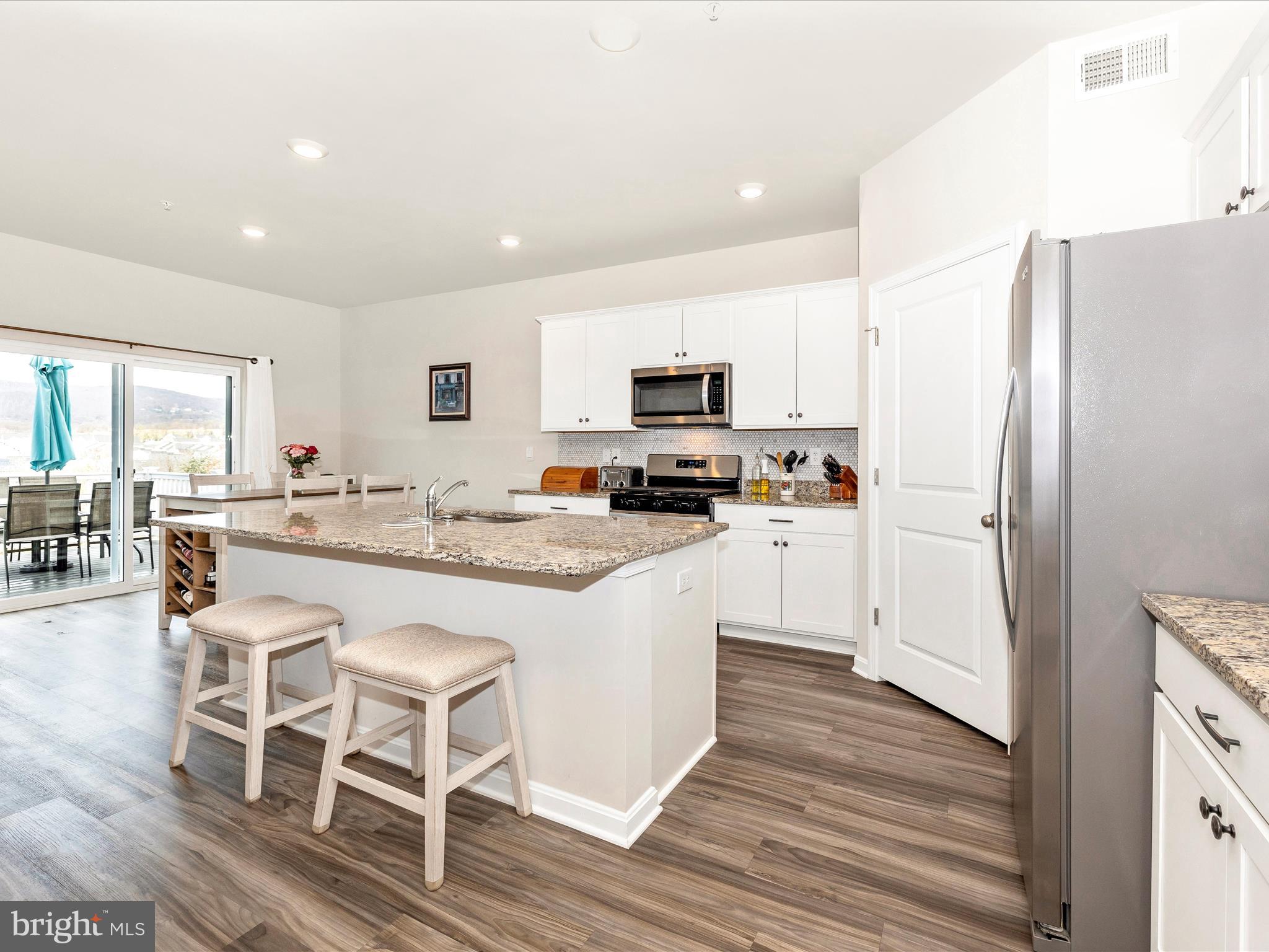 2088 Pomona Way Frederick, MD 21702 - Photo 5 of 55 a kitchen with stainless steel appliances a refrigerator stove microwave and cabinets