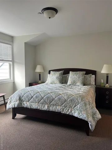 a bedroom with a bed and window