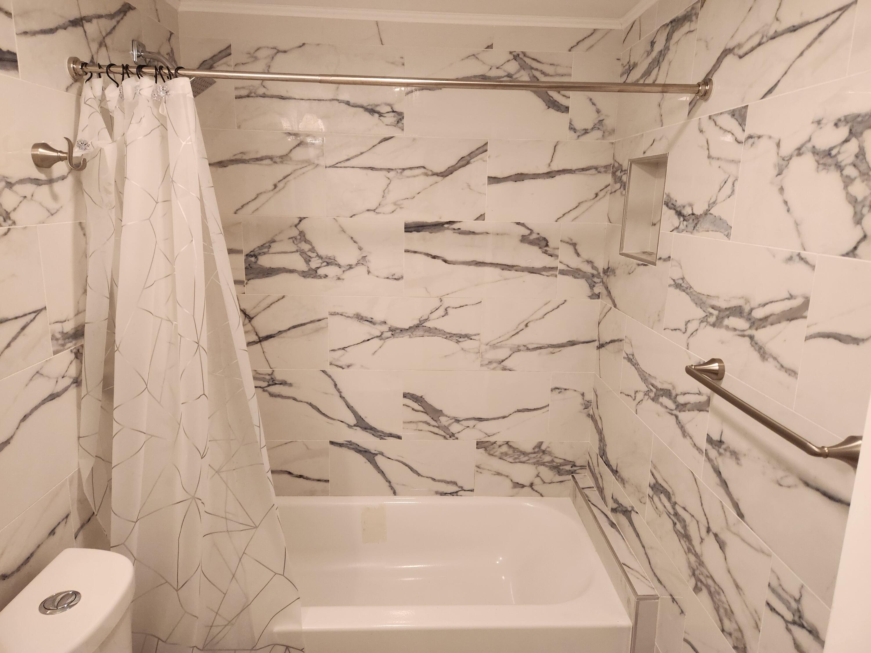 6557 Burning Wood Drive, Unit 215 Boca Raton, FL 33433 - Photo 15 of 22 a bathroom with a bathtub and shower