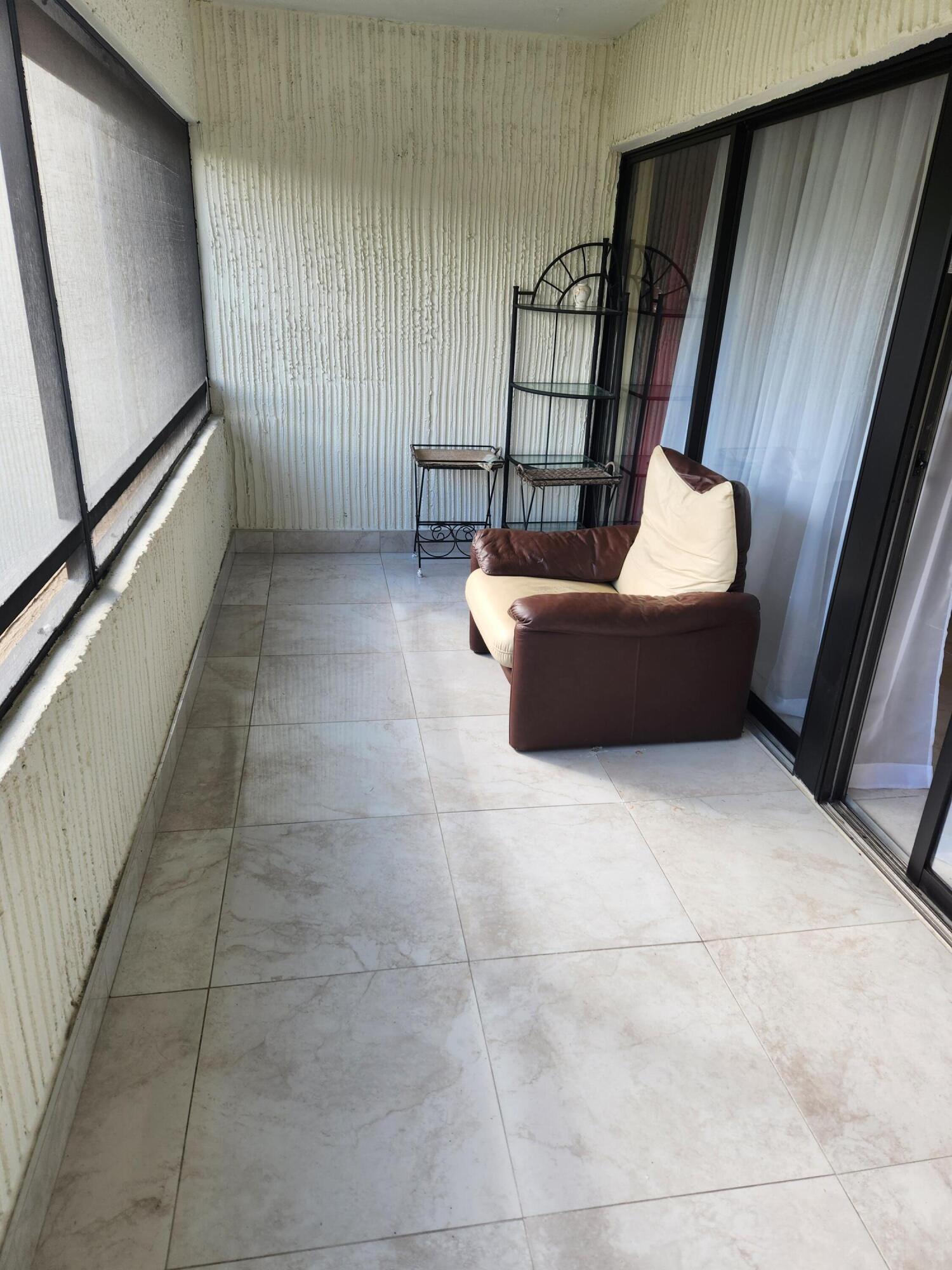 6557 Burning Wood Drive, Unit 215 Boca Raton, FL 33433 - Photo 17 of 22 a room with furniture and window