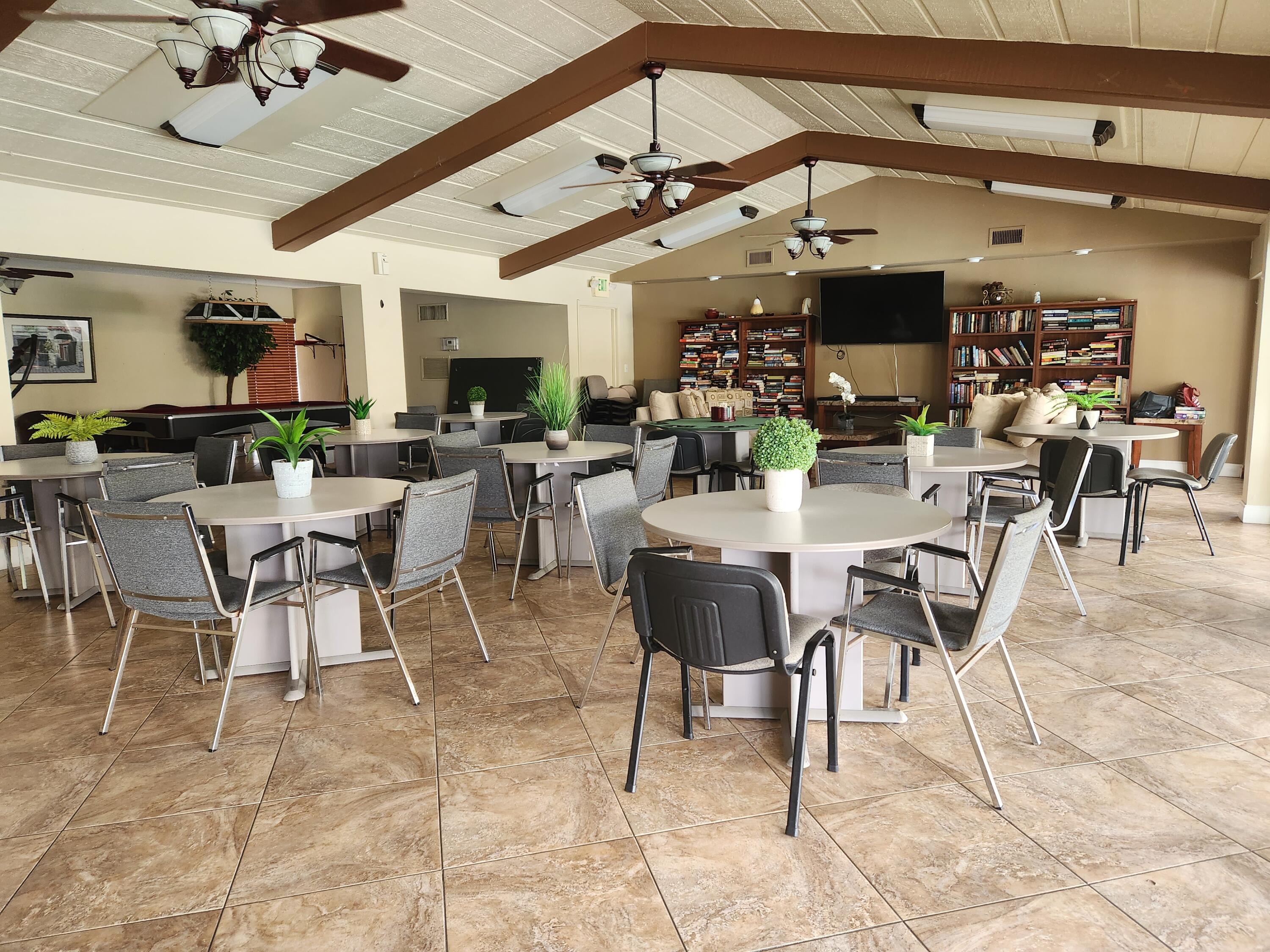 6557 Burning Wood Drive, Unit 215 Boca Raton, FL 33433 - Photo 20 of 22 a view of a dining room with furniture