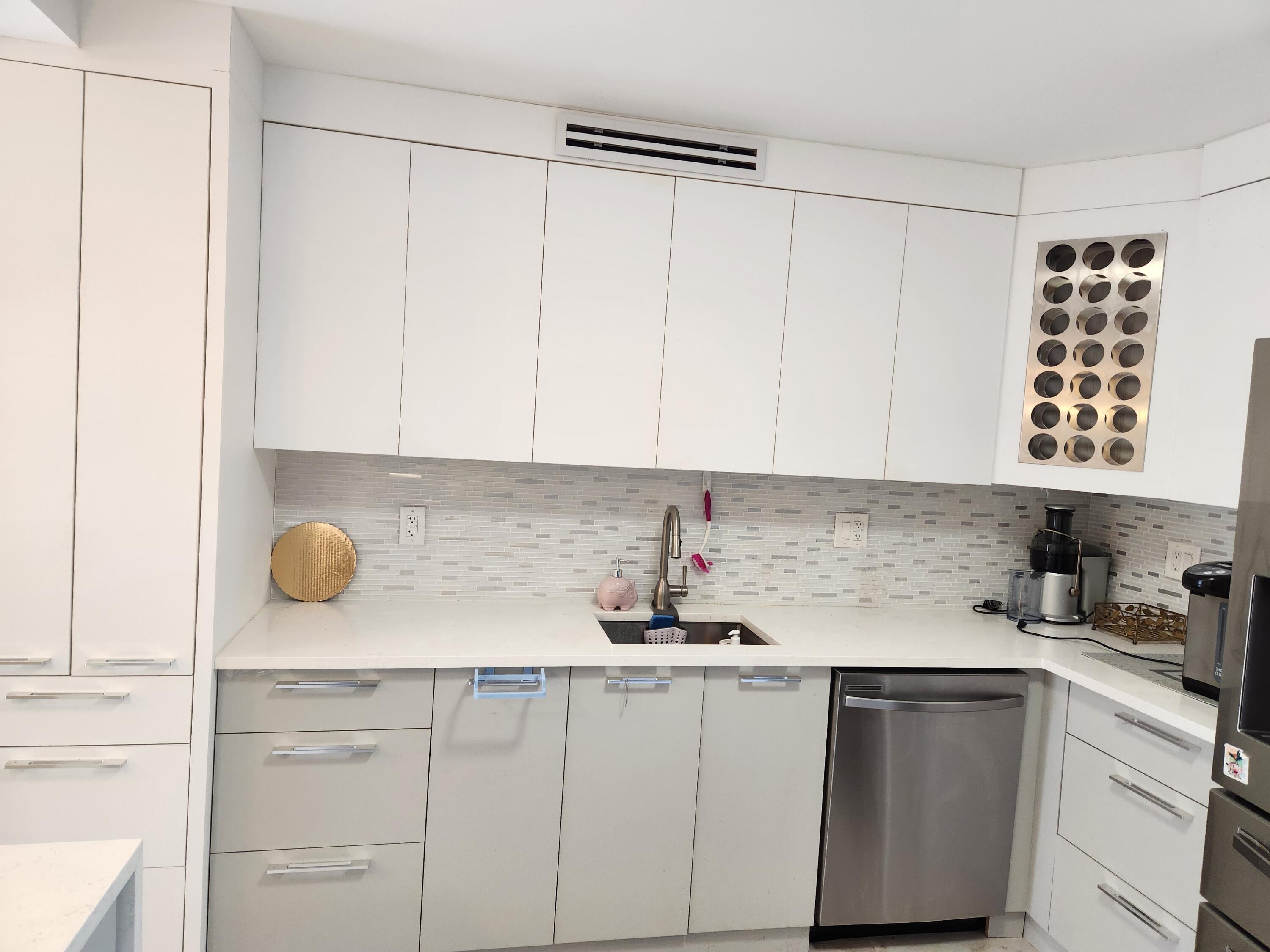 6557 Burning Wood Drive, Unit 215 Boca Raton, FL 33433 - Photo 2 of 22 a kitchen with a sink and cabinets