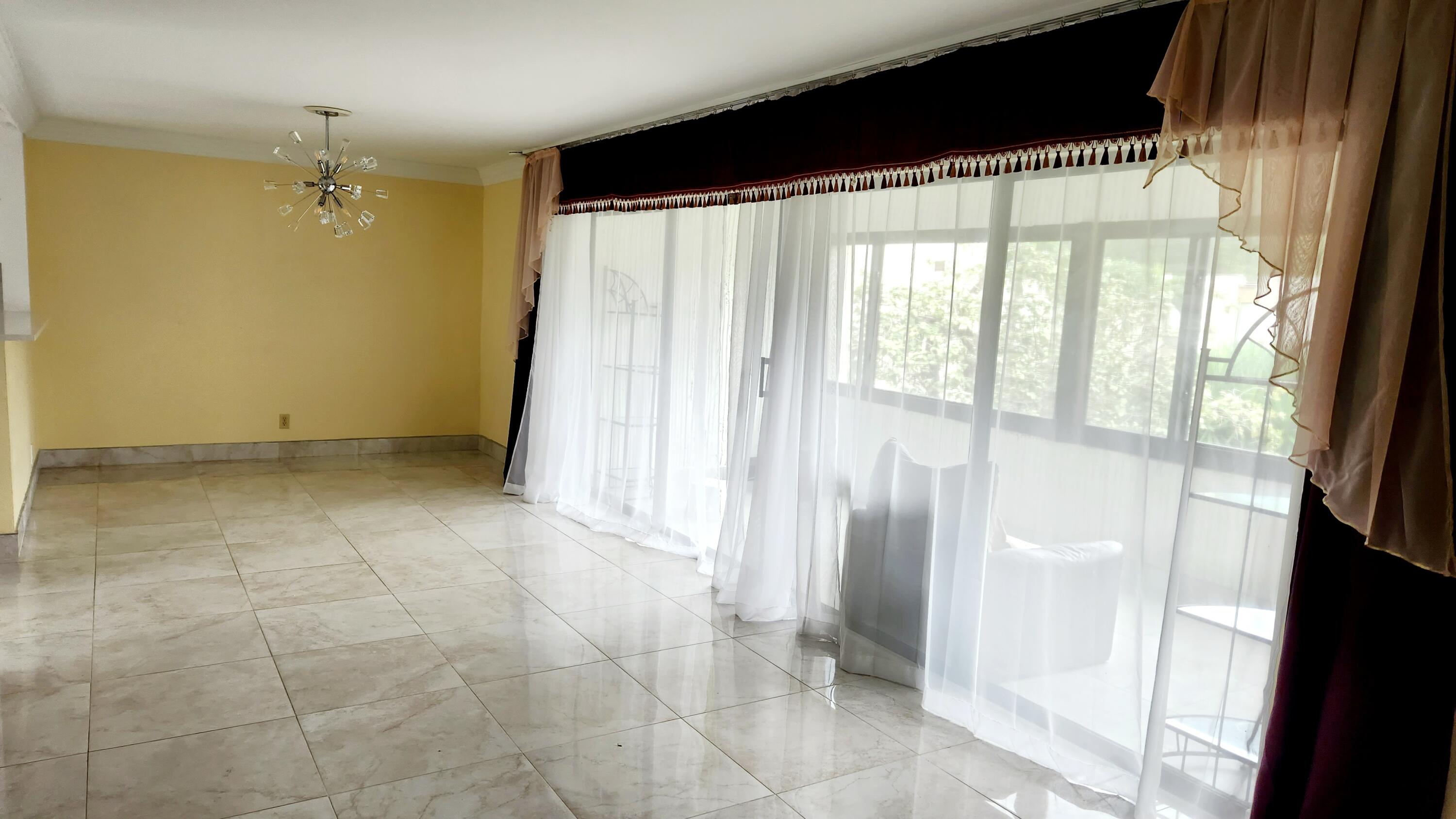 6557 Burning Wood Drive, Unit 215 Boca Raton, FL 33433 - Photo 4 of 22 a view of an empty room with a window