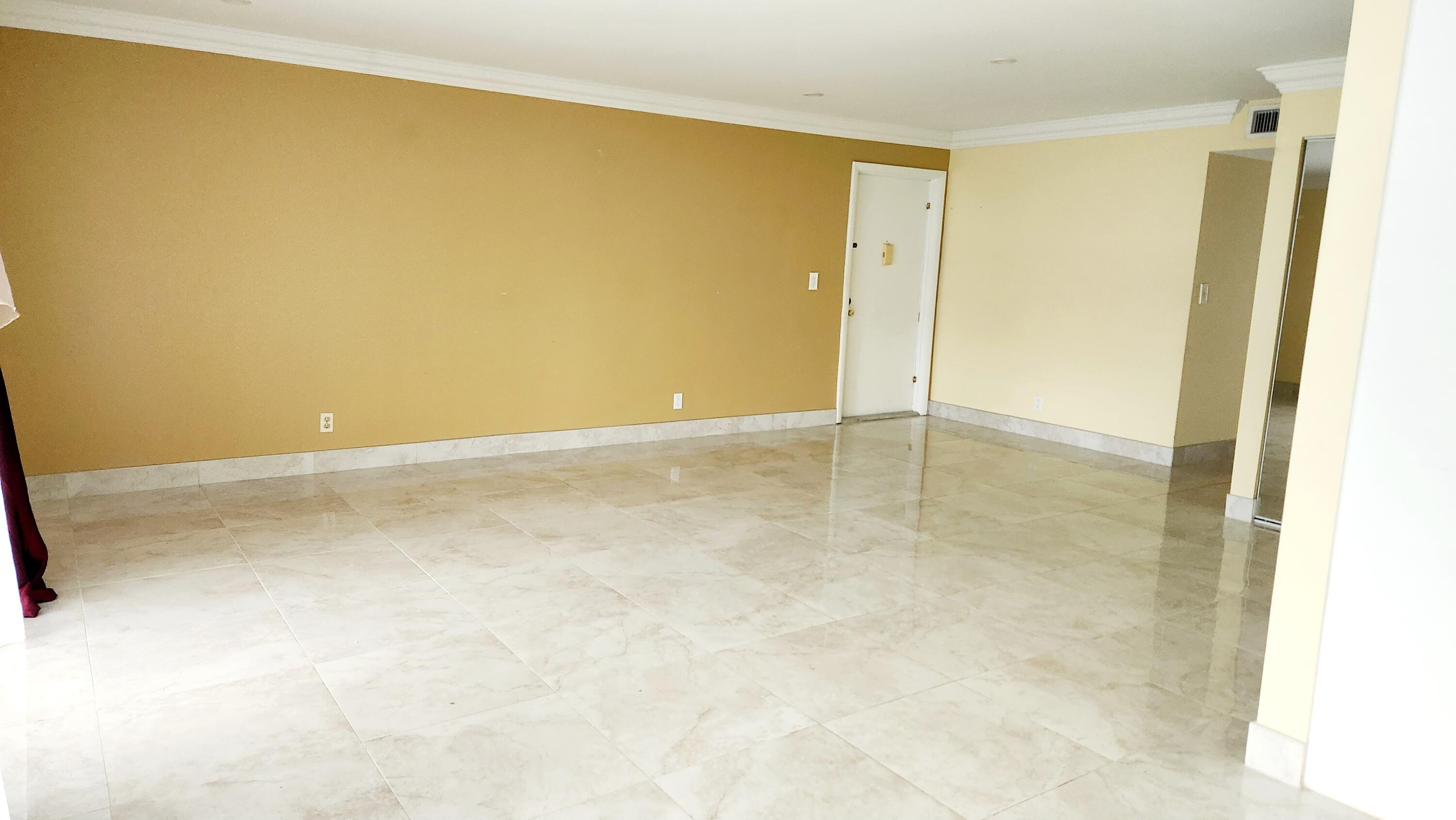 6557 Burning Wood Drive, Unit 215 Boca Raton, FL 33433 - Photo 6 of 22 an empty room with a natural light