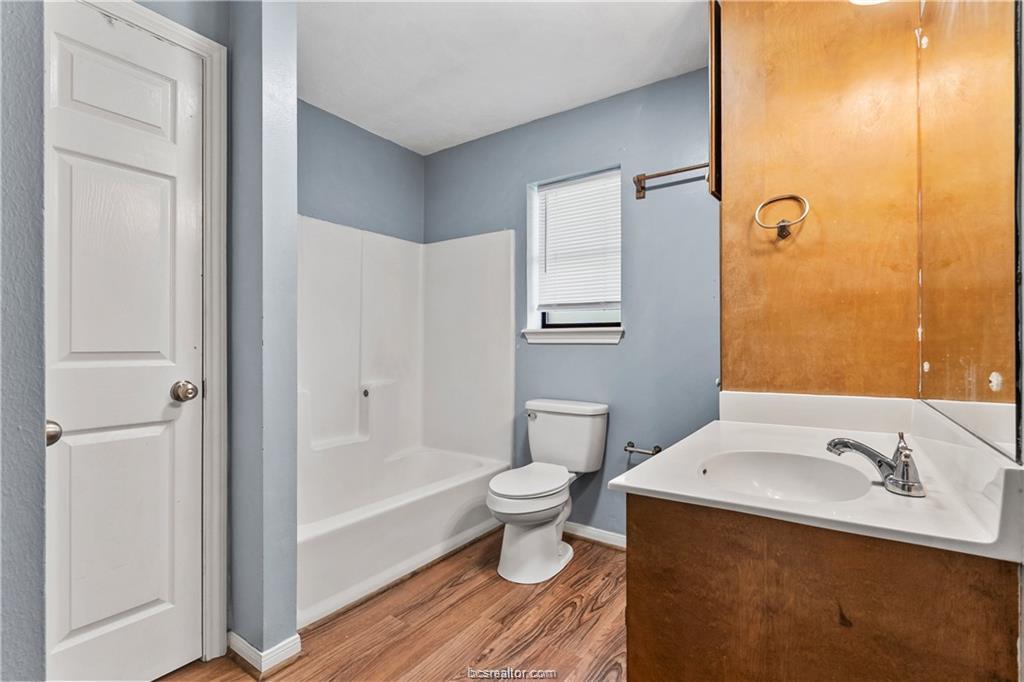 609 Wades Way, Unit 4 Navasota, TX 77868 - Photo 11 of 12 a bathroom with a sink a toilet and shower