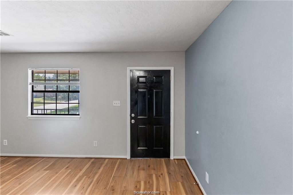 609 Wades Way, Unit 4 Navasota, TX 77868 - Photo 3 of 12 wooden floor in an empty room