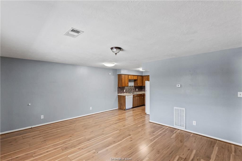 609 Wades Way, Unit 4 Navasota, TX 77868 - Photo 5 of 12 a view of a room with wooden floor and white walls