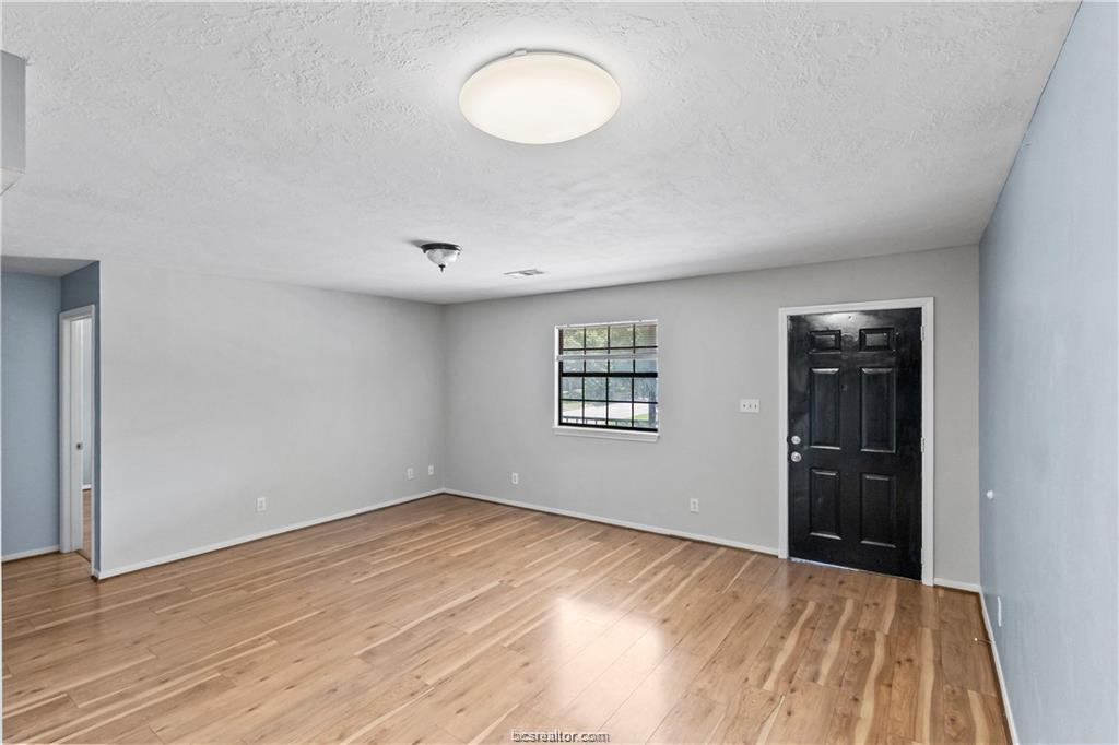 609 Wades Way, Unit 4 Navasota, TX 77868 - Photo 6 of 12 an empty room with windows and closet
