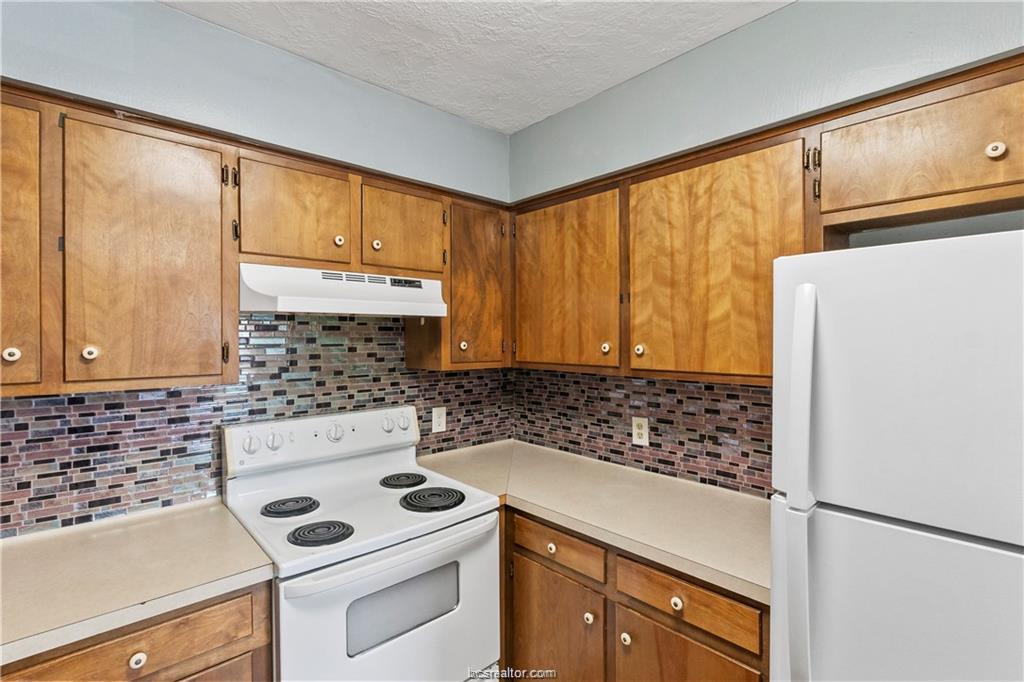 609 Wades Way, Unit 4 Navasota, TX 77868 - Photo 9 of 12 a kitchen with a sink a stove and cabinets