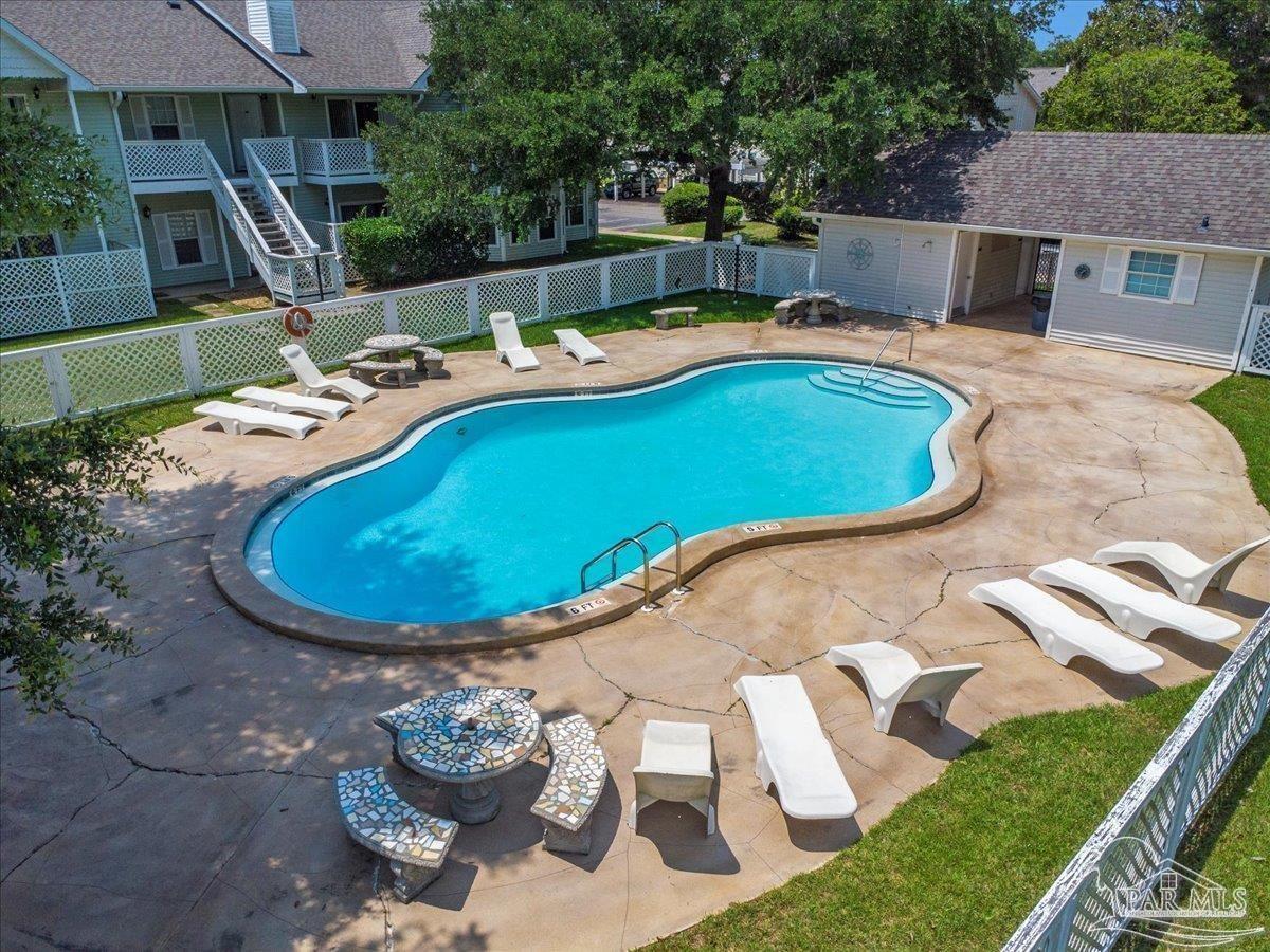a view of a swimming pool with a yard