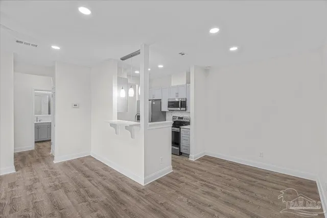 a view of a kitchen cabinets and wooden floor