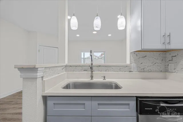 a kitchen with a sink and cabinets