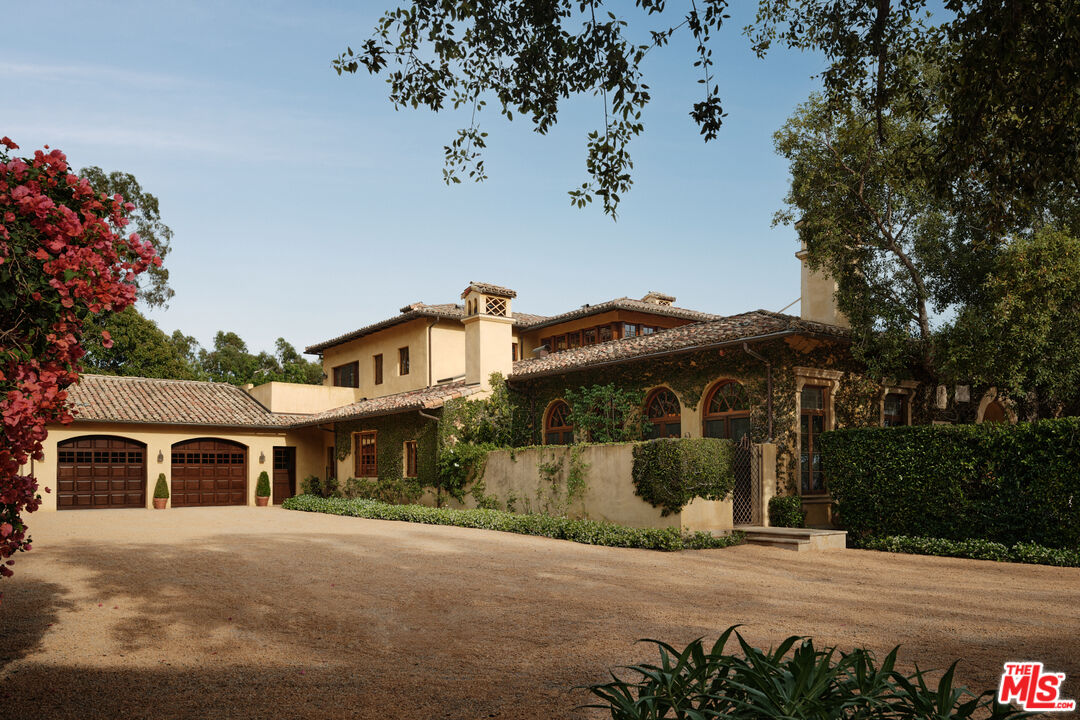 10939 Chalon Road Los Angeles, CA 90077 - Photo 22 of 24 a front view of a house with a garden