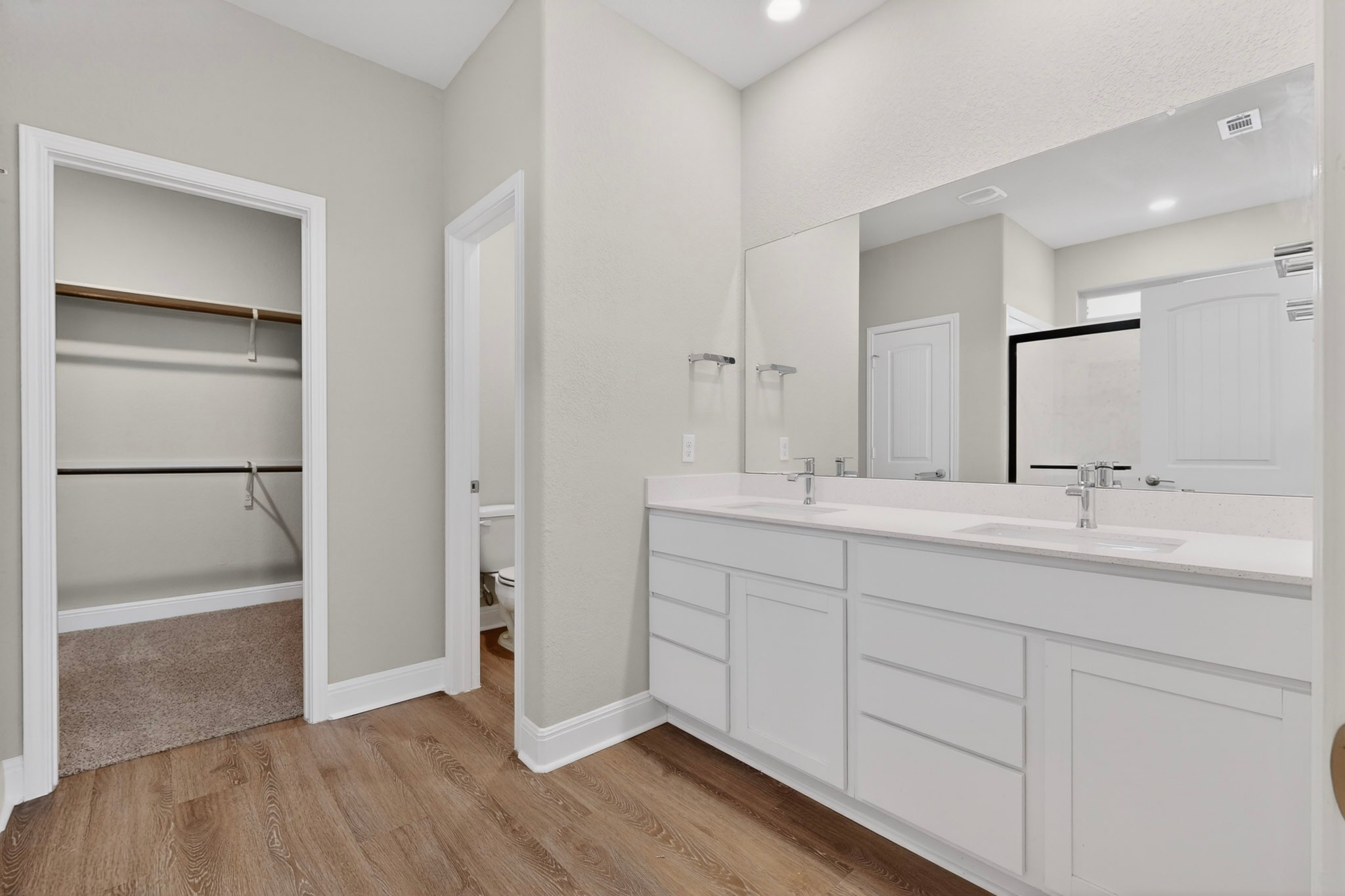 16809 Guido Cove Pflugerville, TX 78660 - Photo 18 of 40 Bathroom featuring a double vanity with white cabinetry, white countertops, and chrome fixtures