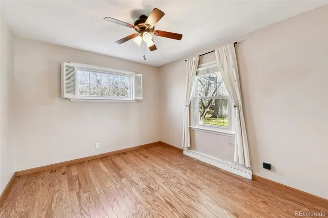 wooden floor in an empty room with a window