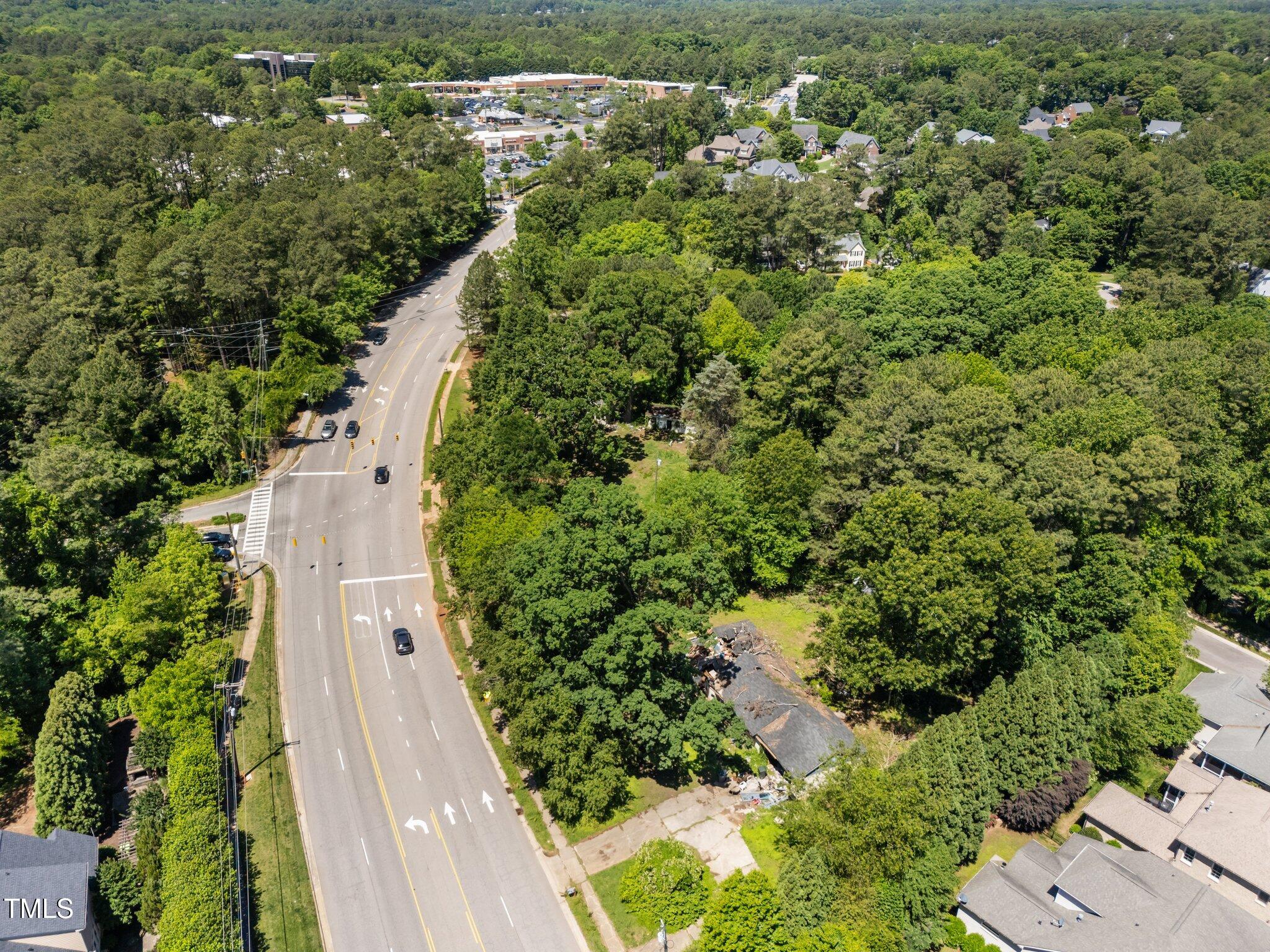 1910 West Millbrook Road Raleigh, NC 27612 - Photo 1 of 8 an aerial view of residential house with outdoor space and trees all around