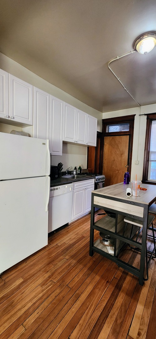2152 West Iowa Street, Unit 1 Chicago, IL 60622 - Photo 2 of 10 a view of kitchen with cabinets and wooden floor