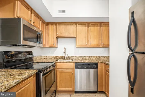 a view of a kitchen with a refrigerator and countertop