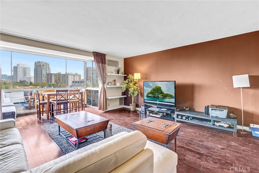 969 Hilgard Avenue, Unit 706 Los Angeles, CA 90024 - Photo 11 of 27 a living room with furniture a flat screen tv and a large window