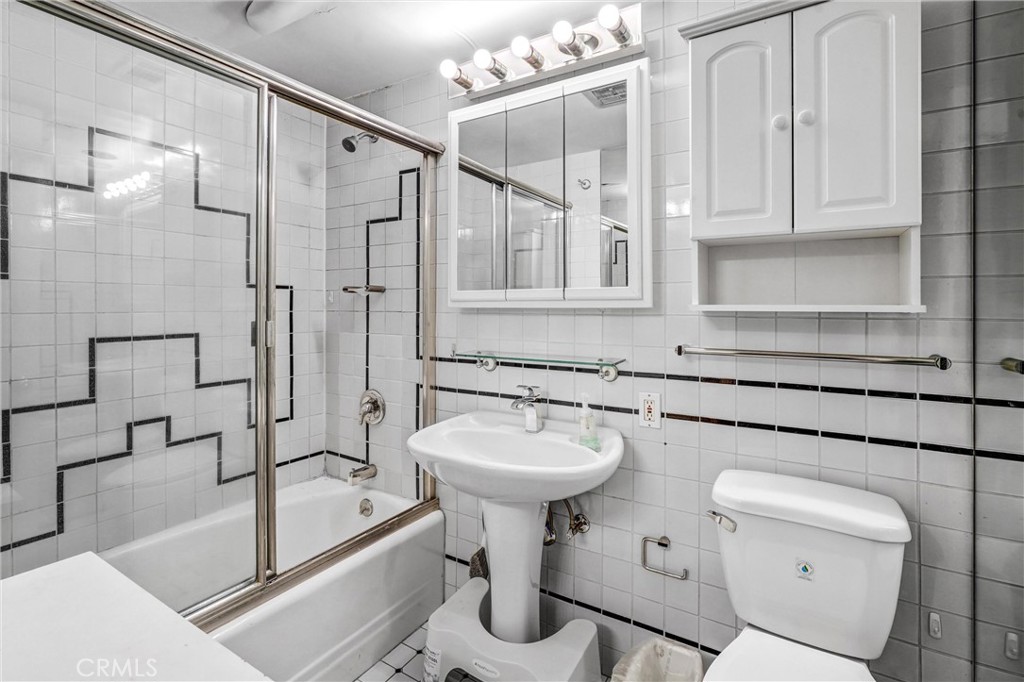 969 Hilgard Avenue, Unit 706 Los Angeles, CA 90024 - Photo 19 of 27 a bathroom with a sink a toilet and shower