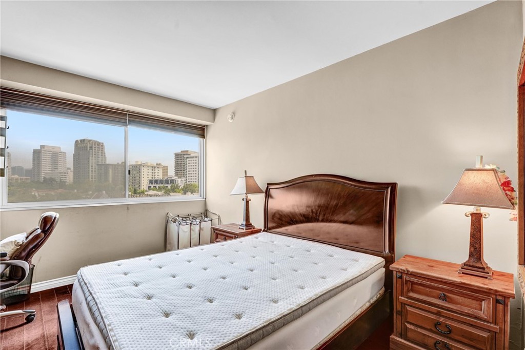 969 Hilgard Avenue, Unit 706 Los Angeles, CA 90024 - Photo 20 of 27 a bedroom with a bed and a table in it