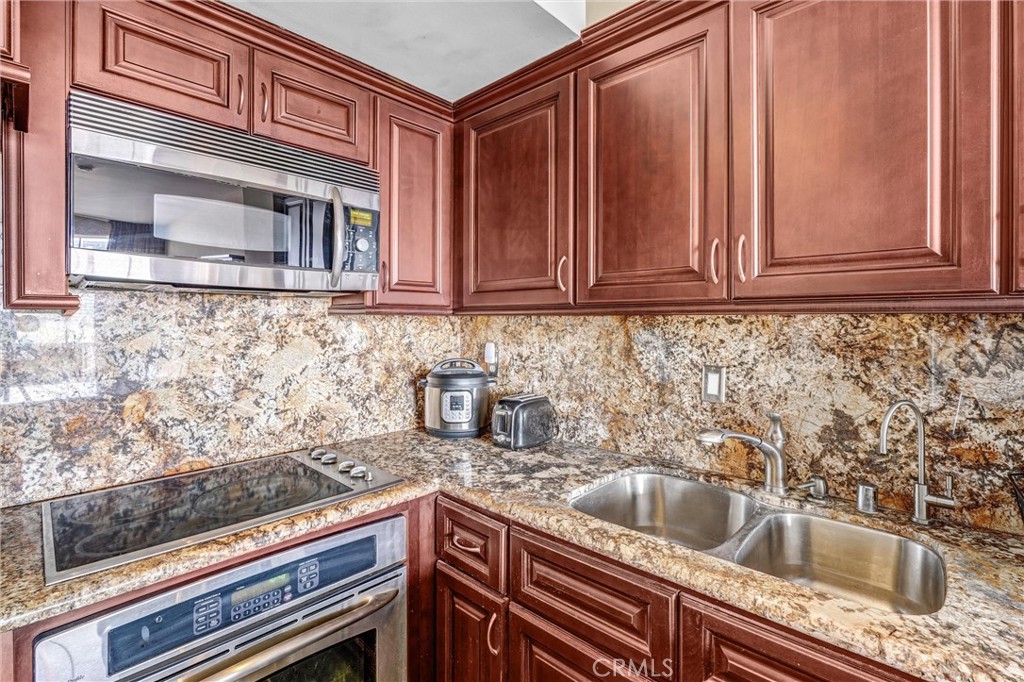 969 Hilgard Avenue, Unit 706 Los Angeles, CA 90024 - Photo 8 of 27 a kitchen with granite countertop a sink and cabinets