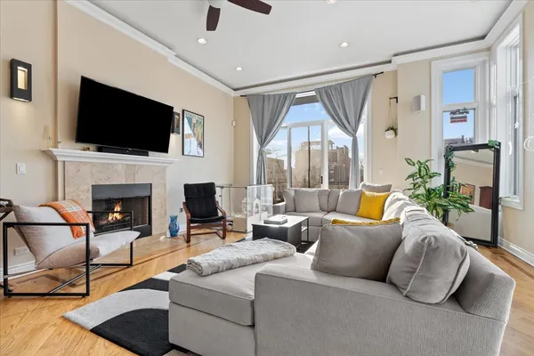a living room with fireplace furniture and a flat screen tv