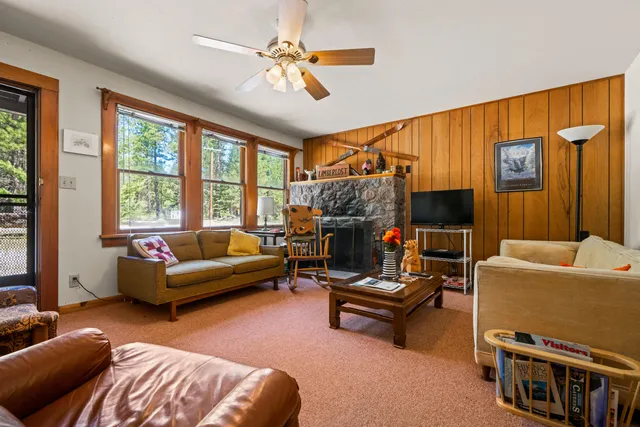 a living room with furniture a flat screen tv and a window