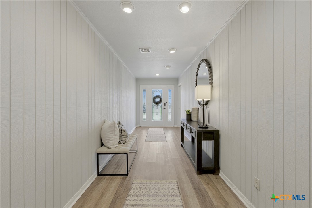 1710 Old Mill Road, Unit 12 Salado, TX 76571 - Photo 19 of 42 a view of a hallway with wooden floor and staircase