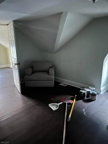 a living room with furniture a air conditioner vent and a window