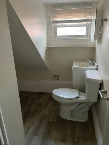 a white toilet sitting next to a window